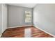 Bedroom featuring hardwood floors and natural lighting at 15709 Leatherleaf Ln, Land O Lakes, FL 34638