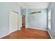 Well-lit bedroom with wood-look floors, closet, and decorative wall art at 15709 Leatherleaf Ln, Land O Lakes, FL 34638