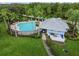 Aerial view featuring the community pool, including lounge chairs and tables at 15709 Leatherleaf Ln, Land O Lakes, FL 34638