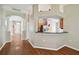 Open-concept entryway with hardwood floors, decorative columns, and an arched doorway for welcoming guests at 15709 Leatherleaf Ln, Land O Lakes, FL 34638