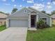 Charming single-story home with a well-maintained lawn and attached two-car garage at 15709 Leatherleaf Ln, Land O Lakes, FL 34638