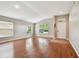 Open living room featuring wood floors, vaulted ceilings, and lots of natural light at 15709 Leatherleaf Ln, Land O Lakes, FL 34638