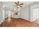 Open floor plan view of the living room with hardwood floors, kitchen bar, and bright, neutral colors at 15709 Leatherleaf Ln, Land O Lakes, FL 34638