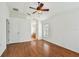 A main bedroom with hardwood floors, a ceiling fan, and an ensuite bathroom featuring a bathtub and a walk-in shower at 15709 Leatherleaf Ln, Land O Lakes, FL 34638
