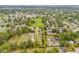 Aerial view of a property outlined in yellow near a park with a school and lush green trees at 1607 Bell Shoals Rd, Brandon, FL 33511