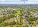 Aerial view of a property outlined in yellow near a park with a school and lush green trees at 1607 Bell Shoals Rd, Brandon, FL 33511
