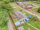 Aerial view showcasing the home, fenced backyard with a pool, and the surrounding neighborhood at 1607 Bell Shoals Rd, Brandon, FL 33511