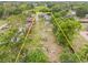 Aerial view of a tree lined property, bordered in yellow, leading to a single Gathering home at 1607 Bell Shoals Rd, Brandon, FL 33511