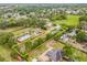 Aerial view of a property outlined in yellow nestled among lush green trees, located in a well established neighborhood at 1607 Bell Shoals Rd, Brandon, FL 33511
