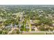 Aerial view of the property bordered in yellow, nestled in an established neighborhood surrounded by lush trees at 1607 Bell Shoals Rd, Brandon, FL 33511