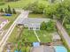 Aerial view highlighting the home's exterior, fire pit, chicken coop, and well-maintained yard at 1607 Bell Shoals Rd, Brandon, FL 33511