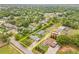 Aerial view of a property outlined in yellow nestled among lush green trees, located in a well established neighborhood at 1607 Bell Shoals Rd, Brandon, FL 33511