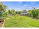 Beautiful backyard with luscious green grass, mature trees, and a wood fence at 1607 Bell Shoals Rd, Brandon, FL 33511