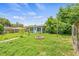 View of a home's backyard with brick fire pit and partial fence line at 1607 Bell Shoals Rd, Brandon, FL 33511