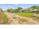 View of a home's exterior with a dirt driveway and partial yard at 1607 Bell Shoals Rd, Brandon, FL 33511