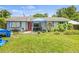 View of a home's exterior with a small front yard and various plants at 1607 Bell Shoals Rd, Brandon, FL 33511