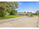 A cozy home with a carport and long driveway, set against a backdrop of lush greenery and clear blue skies at 1607 Bell Shoals Rd, Brandon, FL 33511