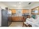 View of a kitchen and eating area with tile floors and wood cabinets at 1607 Bell Shoals Rd, Brandon, FL 33511