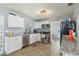 Modern kitchen featuring stainless steel appliances, granite countertops, and white cabinets at 1607 Bell Shoals Rd, Brandon, FL 33511
