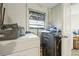 Convenient laundry room area with washer, dryer, and lots of light from a window at 1607 Bell Shoals Rd, Brandon, FL 33511