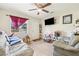 View of a living room with gray sofas, a large window, and a tv at 1607 Bell Shoals Rd, Brandon, FL 33511