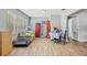 Bright living room with wood floors, a cozy couch, and a charming dining area at 1607 Bell Shoals Rd, Brandon, FL 33511
