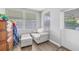 Cozy sitting area with neutral walls, bright windows, and an entry door at 1607 Bell Shoals Rd, Brandon, FL 33511