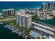 Stunning aerial view of a beachfront condominium with a private marina, pool, and beautiful coastal scenery at 1621 Gulf Blvd # 407, Clearwater Beach, FL 33767