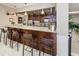 Stylish bar with granite countertops, seating, and stainless steel appliances at 1621 Gulf Blvd # 407, Clearwater Beach, FL 33767
