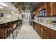 Modern bar with granite countertops, seating, and stainless steel appliances at 1621 Gulf Blvd # 407, Clearwater Beach, FL 33767