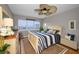 Comfortable bedroom featuring a cozy bed, bright window, and a coastal-themed decor at 1621 Gulf Blvd # 407, Clearwater Beach, FL 33767