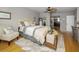 This bedroom features a ceiling fan, bamboo flooring and a chest at the foot of the bed at 1621 Gulf Blvd # 407, Clearwater Beach, FL 33767