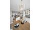 Dining area features a chandelier, wood table with seating, and an open floor plan into the modern kitchen at 1621 Gulf Blvd # 407, Clearwater Beach, FL 33767