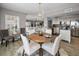 Dining area features a modern chandelier, wood table with seating, and an open floor plan into the living room at 1621 Gulf Blvd # 407, Clearwater Beach, FL 33767