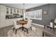 Cozy dining area with a round table, stylish chairs, and a built-in display cabinet at 1621 Gulf Blvd # 407, Clearwater Beach, FL 33767