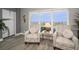 Cozy seating area with views from the window is bathed in natural light at 1621 Gulf Blvd # 407, Clearwater Beach, FL 33767