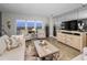 Inviting living room boasts comfortable seating, wood floors, and views from large windows at 1621 Gulf Blvd # 407, Clearwater Beach, FL 33767
