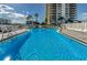 Wide shot of a community pool surrounded by palm trees at 1621 Gulf Blvd # 407, Clearwater Beach, FL 33767