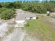 Aerial view of a home with a two-car garage and expansive front yard at 17023 Alderman Turner Rd, Wimauma, FL 33598