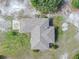 Aerial view of a single-story home with well-maintained landscaping and a gray shingle roof at 17023 Alderman Turner Rd, Wimauma, FL 33598