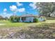 Home featuring a large backyard with mature trees, perfect for outdoor relaxation at 17023 Alderman Turner Rd, Wimauma, FL 33598