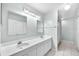 Bathroom featuring double sinks, white cabinets, and tiled floors at 17023 Alderman Turner Rd, Wimauma, FL 33598