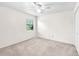 Bright bedroom with neutral carpet, standard closet, and ceiling fan with lighting at 17023 Alderman Turner Rd, Wimauma, FL 33598