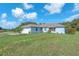Well-kept home featuring an attached garage and spacious front yard at 17023 Alderman Turner Rd, Wimauma, FL 33598