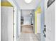 Welcoming foyer featuring white tile flooring, blue and yellow painted walls and access to living room at 17023 Alderman Turner Rd, Wimauma, FL 33598
