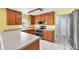 Updated kitchen features stainless steel appliances, wood cabinets, and ample counter space at 17023 Alderman Turner Rd, Wimauma, FL 33598