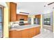 Kitchen featuring stainless steel appliances, peninsula counter, with view into the backyard at 17023 Alderman Turner Rd, Wimauma, FL 33598