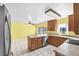 Open kitchen and breakfast nook with tile floors, wood cabinets, and stainless-steel appliances at 17023 Alderman Turner Rd, Wimauma, FL 33598