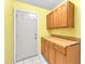 Mud room with tile floor, exterior door, cabinets and countertop for convenience at 17023 Alderman Turner Rd, Wimauma, FL 33598