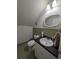 Attic bathroom with tiled floor and walls, white fixtures, and unique architecture at 210 Kingsway Dr, Temple Terrace, FL 33617